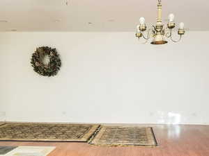 Detailed view of wood finished floors and a chandelier in the Great Room.
