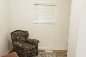 Sitting room featuring baseboards and wood finished floors