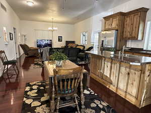 ADU - Dining space with dark wood-style floors and a chandelier