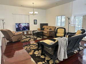 ADU -Living area with dark wood finished floors and French doors