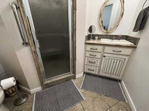 ADU - Bathroom with a shower stall, vanity, and light tile flooring