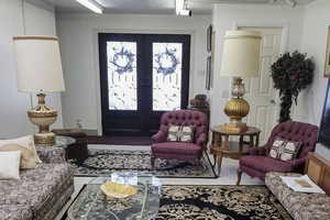 Carpeted foyer entrance with french doors