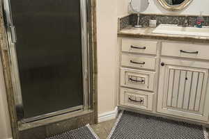 ADU - Master Bathroom with vanity, tiled floors, a stall shower, and decorative backsplash