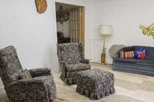 Sitting room featuring baseboards