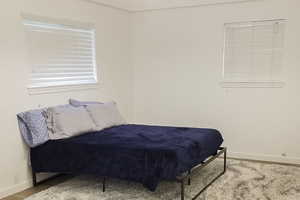 Bedroom featuring wood finished floors and baseboards