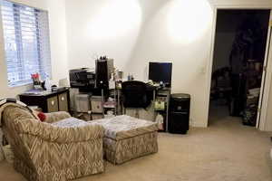 Carpeted office space featuring baseboards