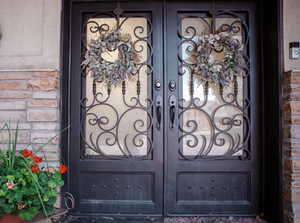 Property entrance featuring brick siding