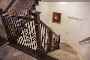 Stairway featuring stone finish flooring and baseboards