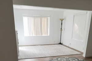 Unfurnished room with baseboards and wood finished floors