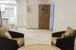 Sitting room featuring a chandelier and light colored carpet