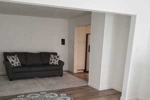 Living area with wood finished floors and baseboards