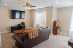 Living area featuring recessed lighting, light carpet, and ceiling fan