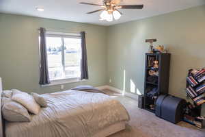 Bedroom with light carpet and ceiling fan