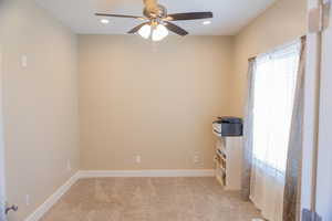 Unfurnished office featuring light colored carpet, a ceiling fan, and recessed lighting