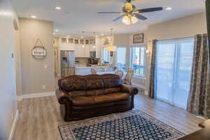 Living area with recessed lighting, light wood-style floors, a ceiling fan, and 9 foot ceilings