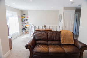 Living area featuring carpet and recessed lighting