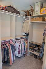 Spacious master closet featuring carpet flooring