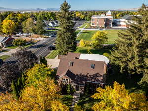 View of subject property featuring a mountainous background and a tree filled landscape