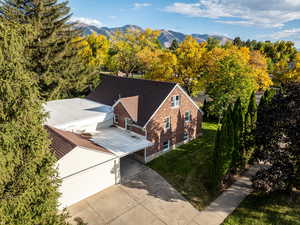 View of subject property with a mountainous background and garage