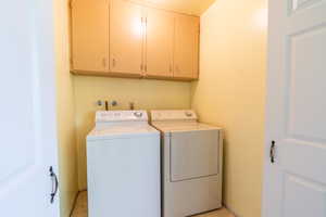 Laundry room featuring cabinet space and washer and dryer