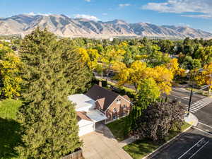 Aerial view of property and surrounding area with a mountain backdrop