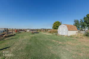 View of yard with a storage unit