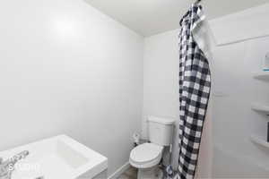 ADU Full bath featuring toilet and a stall shower