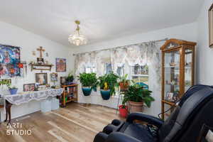 Sitting room featuring wood finished floors and a chandelier