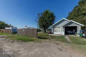 View of yard featuring a detached garage and an outdoor structure