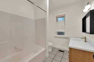 Full bathroom featuring vanity, light tile patterned floors, and tub / shower combination