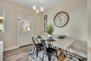 Dining room with a chandelier and light wood finished floors