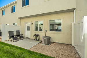 Rear view of property with a patio area and stucco siding