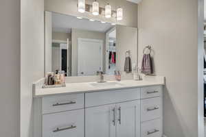 Bathroom with a spacious closet and vanity