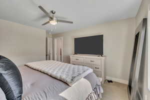 Bedroom with light colored carpet and ceiling fan