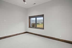 Carpeted Bedroom room with a mountain view, walk in closet and a private bathroom.