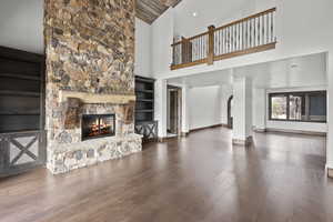 Looking toward Entry, Great room with high vaulted ceiling, hardwood / wood-style flooring, a fireplace, and wood ceiling