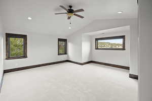 Huge Bedroom with lofted ceiling, light colored carpet, recessed lighting, and a ceiling fan