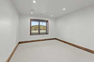 Carpeted bedroom featuring recessed lighting and baseboards