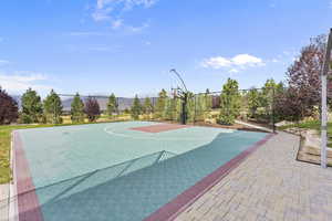 View of sport court with basketball court, a patio, and a mountain view