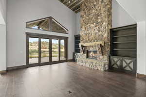 Great room with high vaulted ceiling, hardwood / wood-style flooring, a fireplace, and wood ceiling