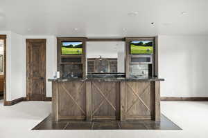 Basement Kitchen with dark stone counters and recessed lighting