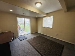 Entryway featuring a textured ceiling, carpet flooring, and recessed lighting