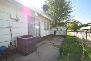 View of side of home featuring a patio area and a central AC unit