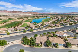Aerial perspective of suburban area with a water and mountain view and a local golf course