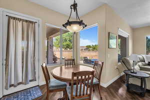 Dining space featuring dark wood-style flooring and baseboards