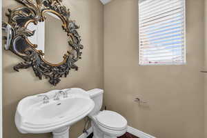 Bathroom with a sink and baseboards