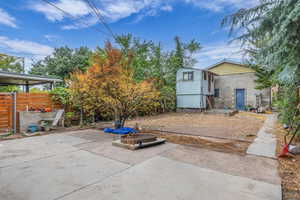 View of patio featuring a vegetable garden and a fire pit