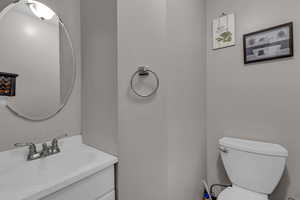 Half bath with vanity and toilet