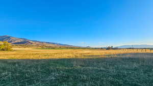 View of mountain backdrop with rural landscape