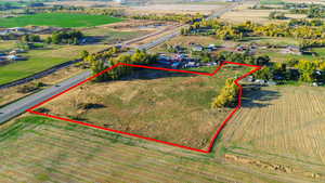 Overview of rural landscape featuring property parcel outlined and large plots for crops